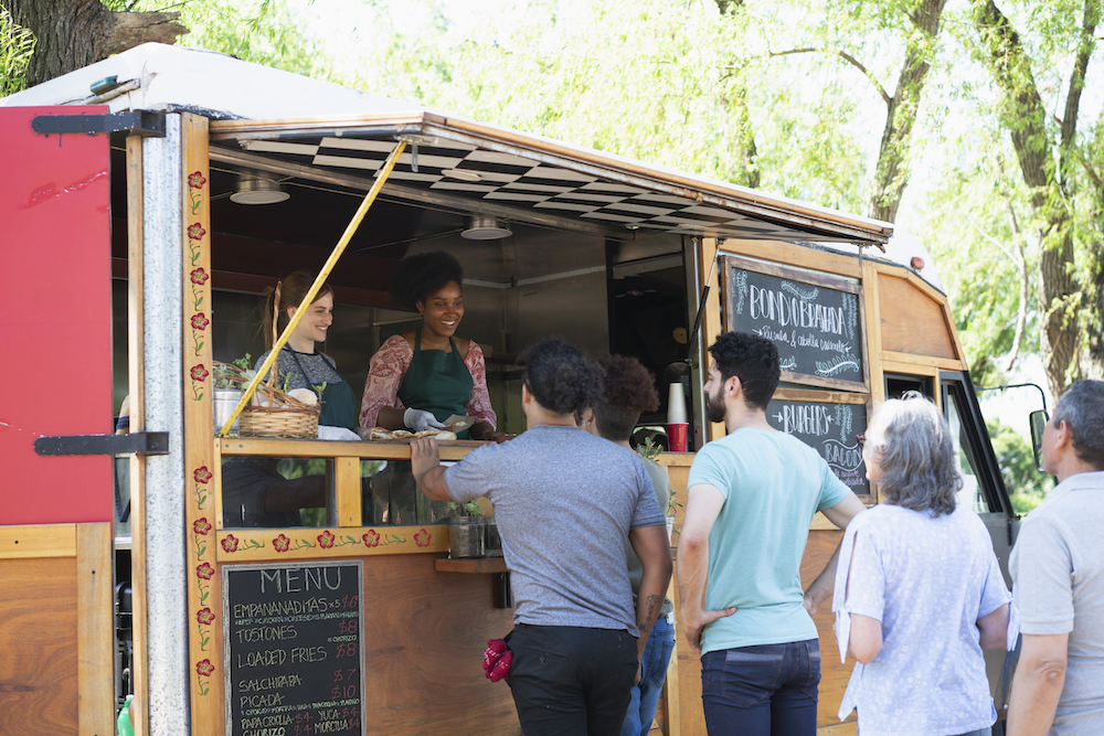 people in line to buy food from food truck