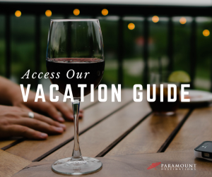 wine glass red wine outdoors text reads access our vacation guide