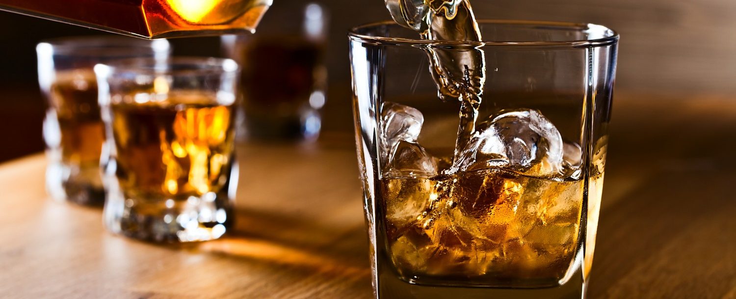 whiskey and natural ice on old wooden table