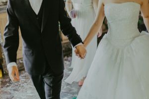 Married couple holding hands at wedding