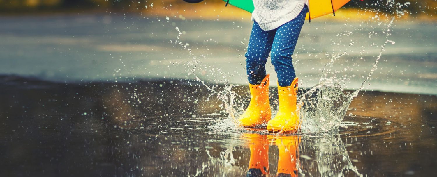 girl plays in puddle