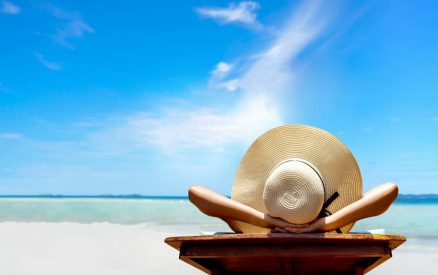midweek stays on the outer banks, woman relaxing on beach