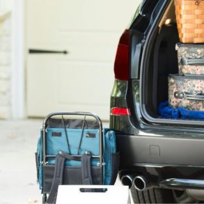boy unloading luggage from car