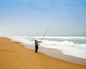 man surf fishing