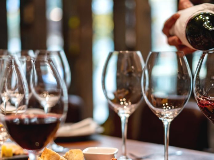 Sommelier serving glasses of winetasting event