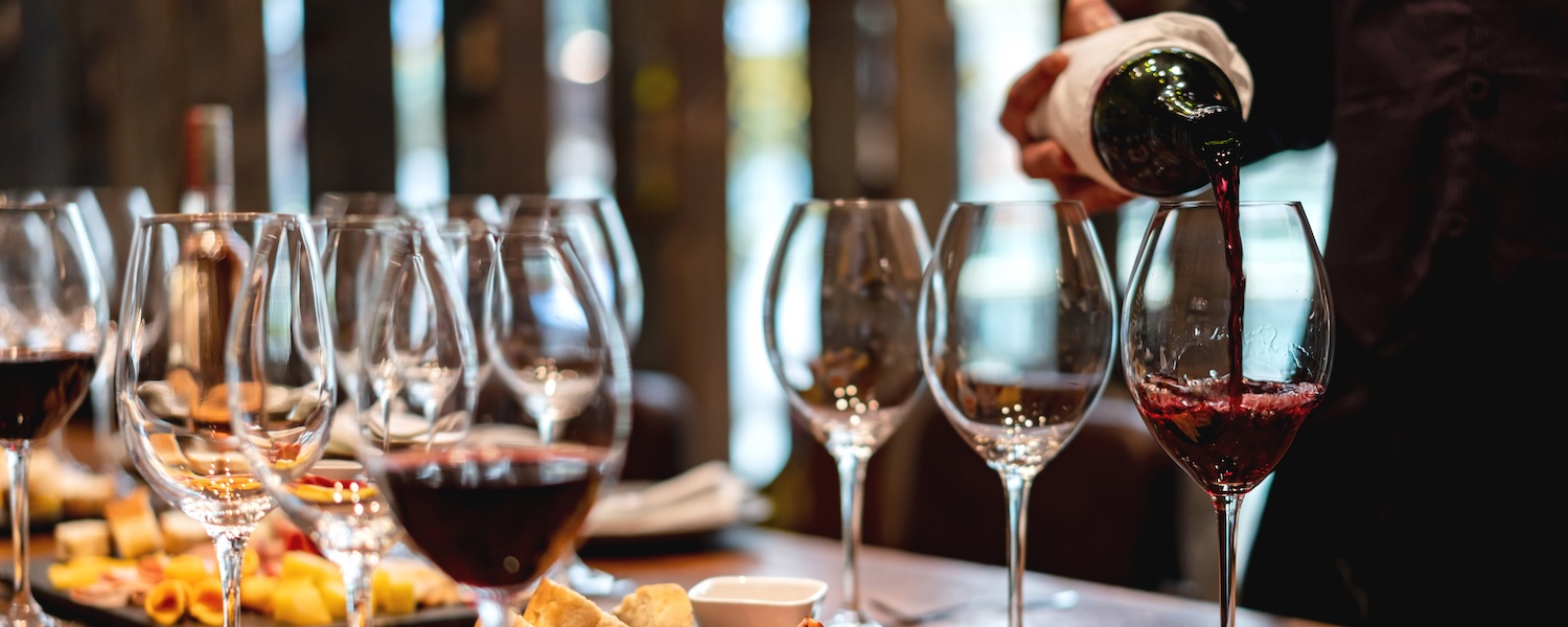 Sommelier serving glasses of winetasting event