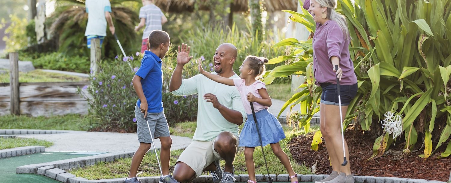 family playing mini golf