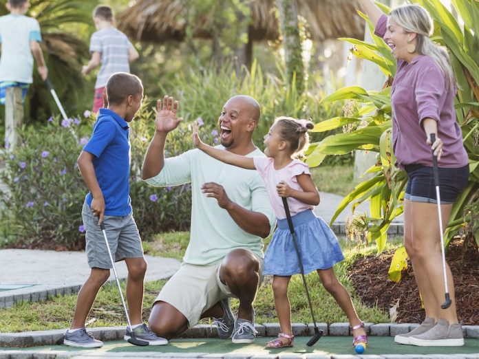family playing mini golf
