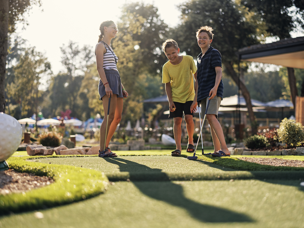 Kids playing mini golf