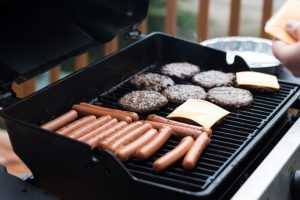 Grill with hamburgers and hot dogs